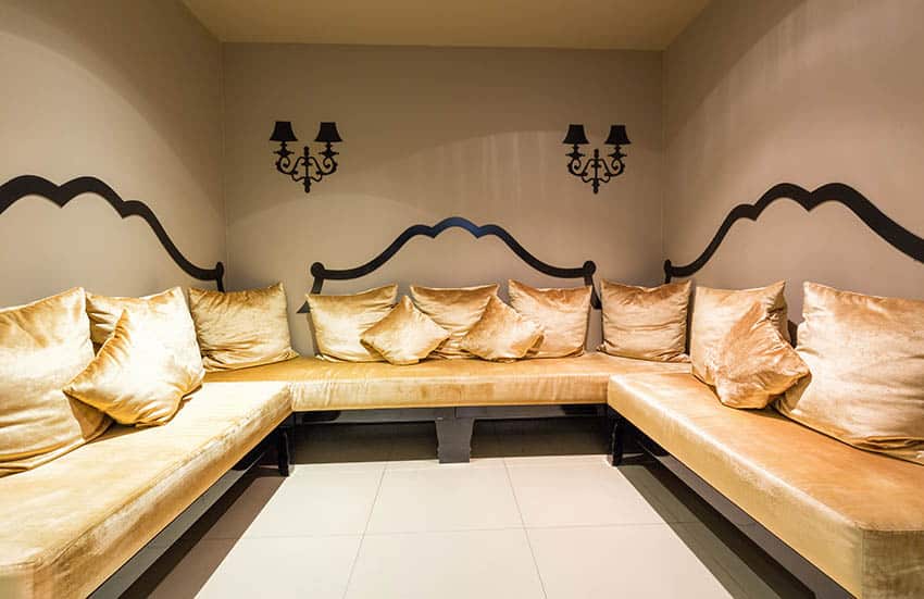 Basement lounge with porcelain tile flooring and wrap around wall couches