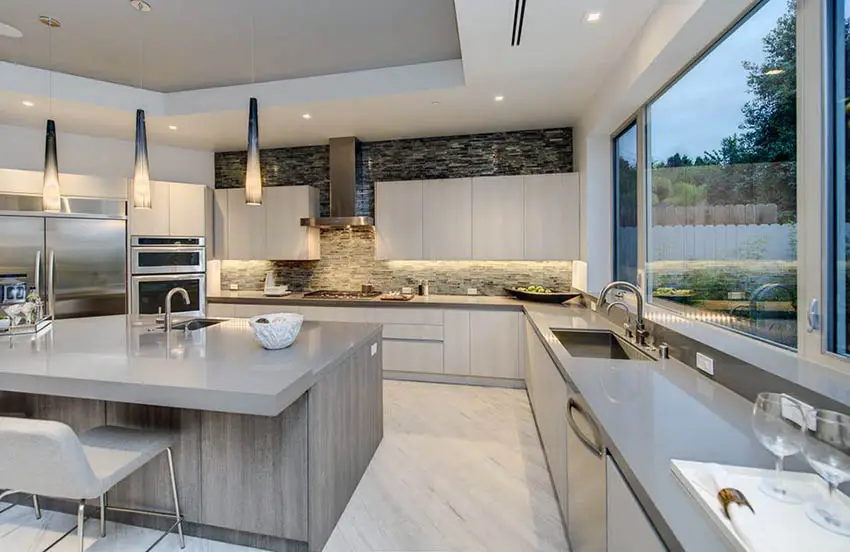 Contemporary kitchen with solid surface counters and sink