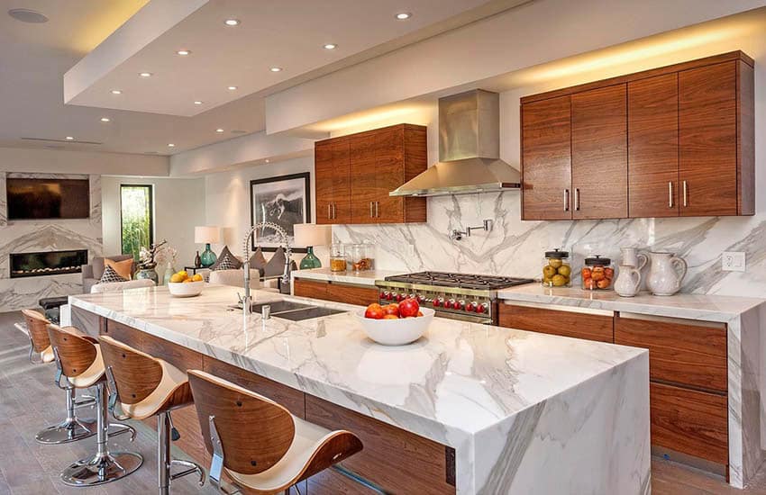 Contemporary kitchen with open concept living room and eat in dining island and marble countertops