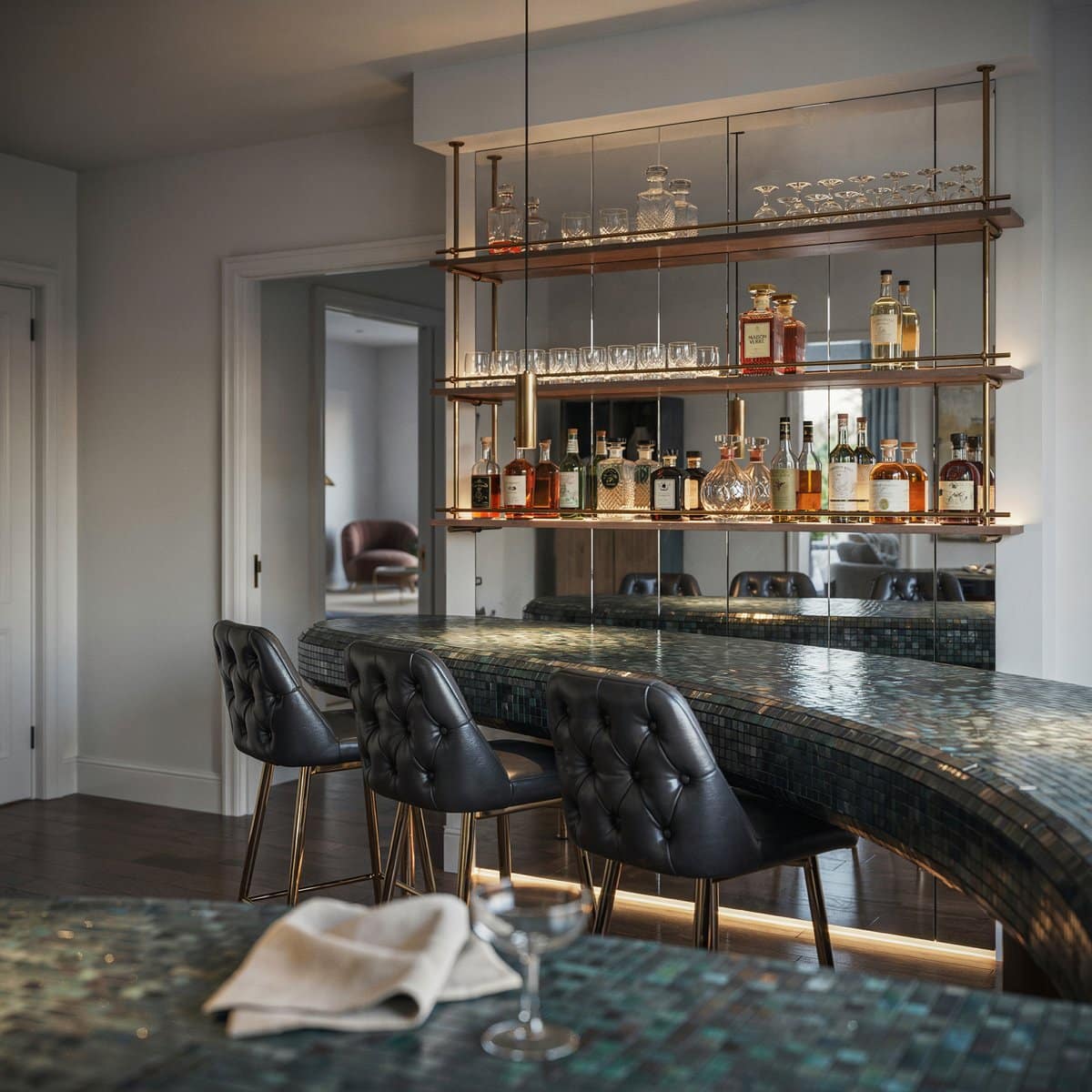 Curved mosaic tile bar counter with black leather stools and mirrored shelves