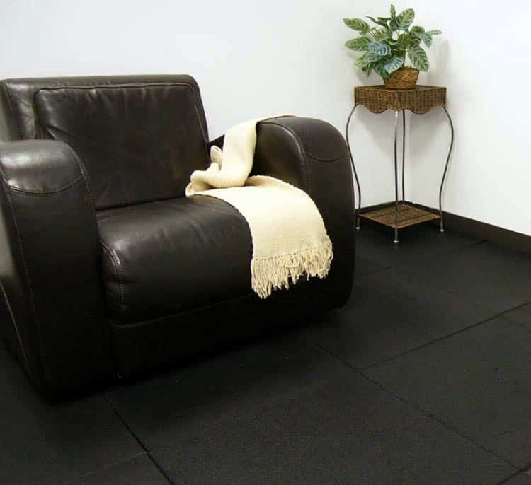 Interlocking rubber tiles for basement floor with black couch