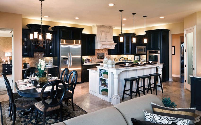 Kitchen with white island and black cabinets next to dining table