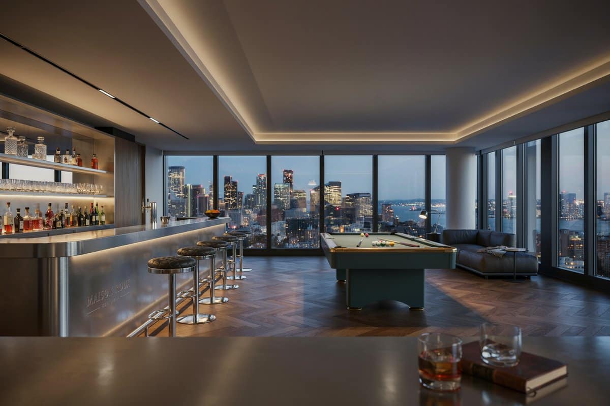 Stainless steel penthouse bar with silver stools and city skyline windows