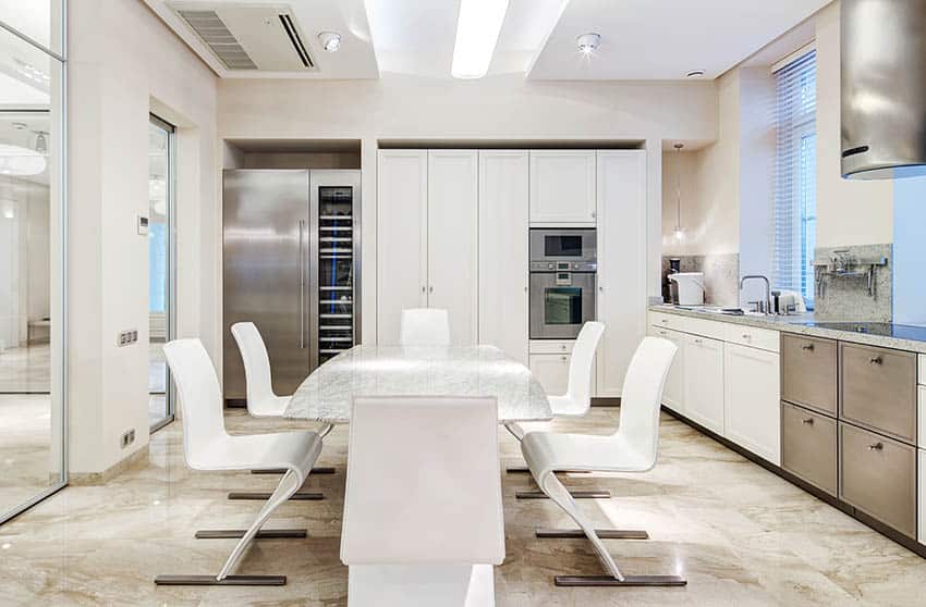 Kitchen with windows with blinds, steel cabinets and bar lights