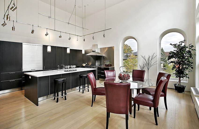 kitchen with black cabinetry and hanging track lighting