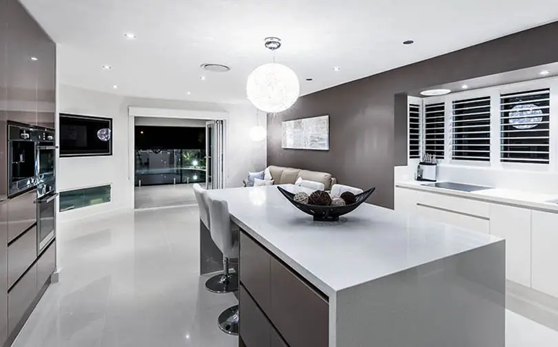 Modern kitchen with dark gray european cabinets with integrated door hardware