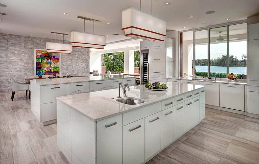 Modern kitchen with retractable handle sink–in island with white marble counters