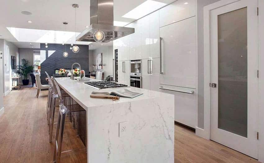 Modern kitchen with white lacquer cabinets and calacatta marble island and miele built in appliances
