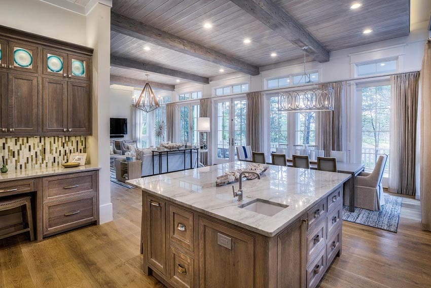 kitchen with plank floors, quartz countertop and beam ceiling