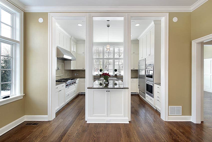 Remodeled kitchen to be open with support beams intact connected to island