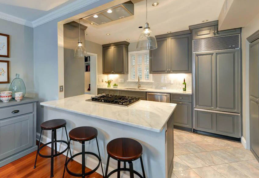 kitchen with marble counters, gray cabinets and peninsula