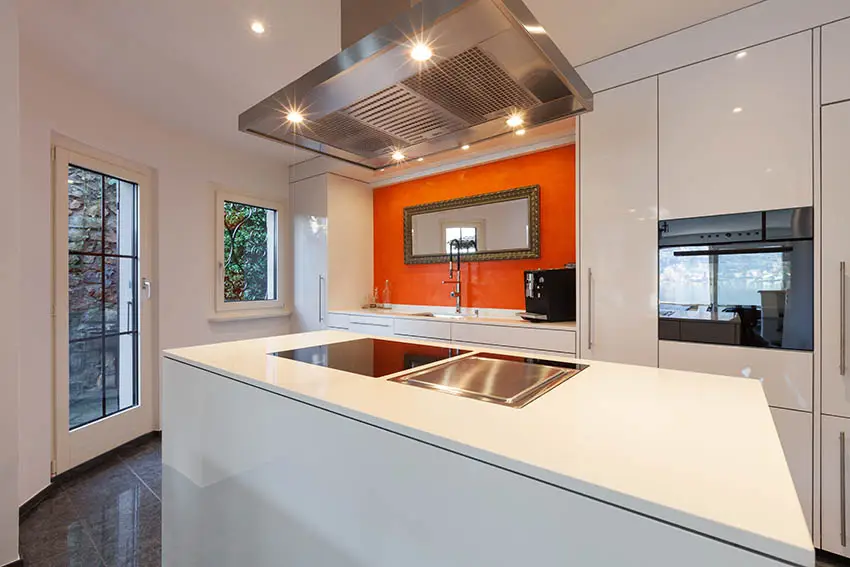 Small modern kitchen with island and orange backsplash