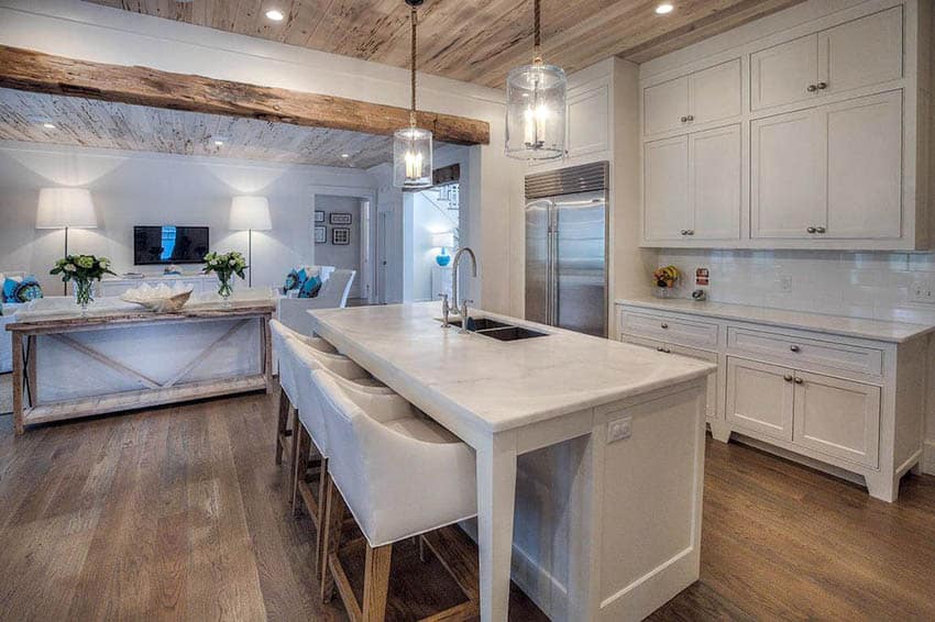 Small cottage kitchen with plank ceiling and marble surfaces