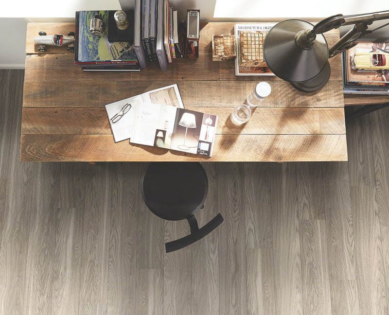 Wood plank style flooring, wood desk with study lamp