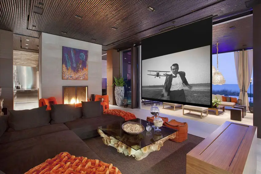 Room with sectional couch and large projector screen