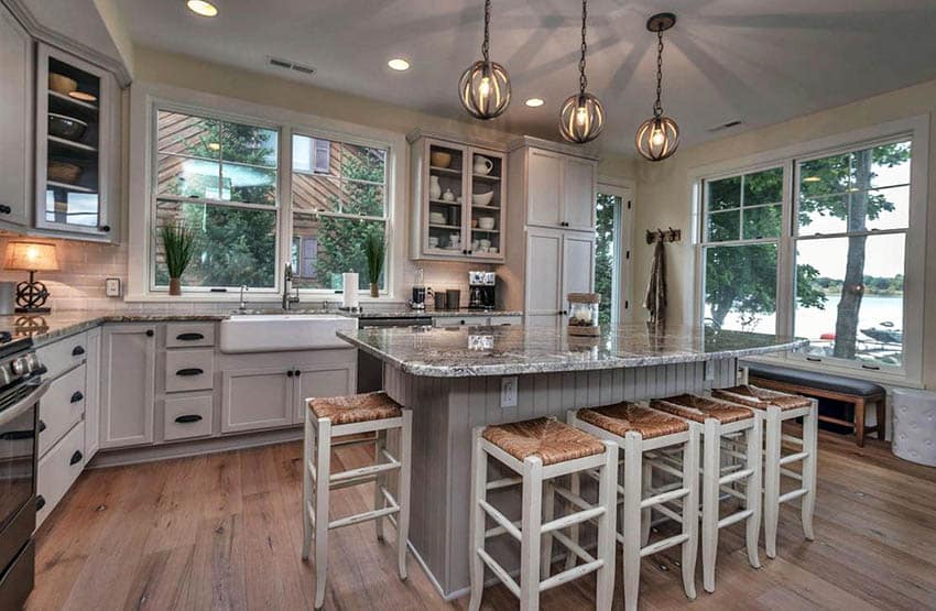 Cottage kitchen with painted gray cabinets breakfast bar island and hickory wood flooring