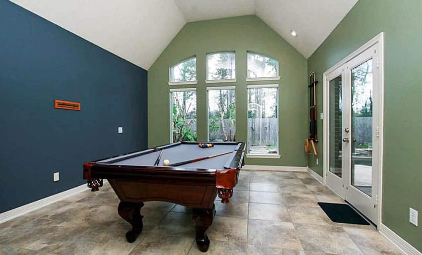 Game room with green wall paint and navy blue accent wall