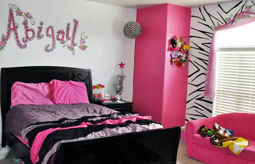 Girls bedroom with personalized painted name on wall