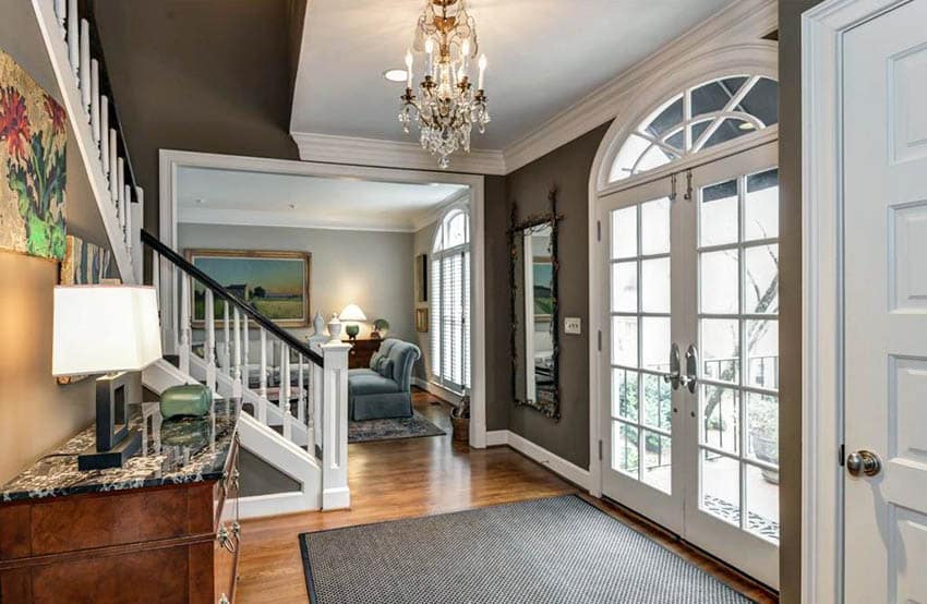 Home entryway with mocha brown paint color walls and wood floors