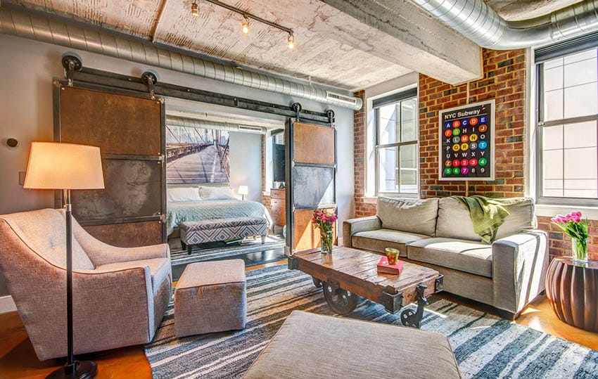 Loft living room with bedroom separated by sliding barn doors