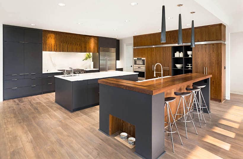 Modern kitchen with gray cabinets and wood cabinets with two islands