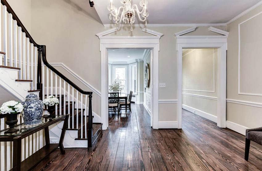 Traditional entryway with wood flooring, chandelier, beige paint and molding