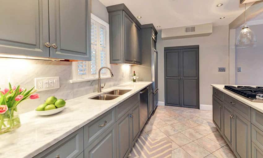 Traditional kitchen with gray cabinets and white calacatta marble countertops