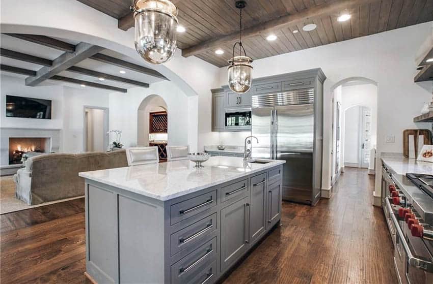 Traditional kitchen with gray cabinets carrara marble counters and hickory wood floors