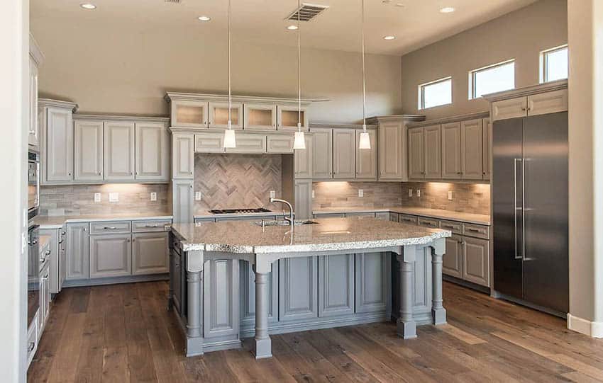 Traditional kitchen with off white cabinets and gray island