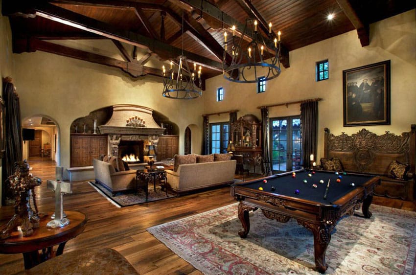 Traditional living room with exposed beam ceiling large fireplace wood floors and pool table