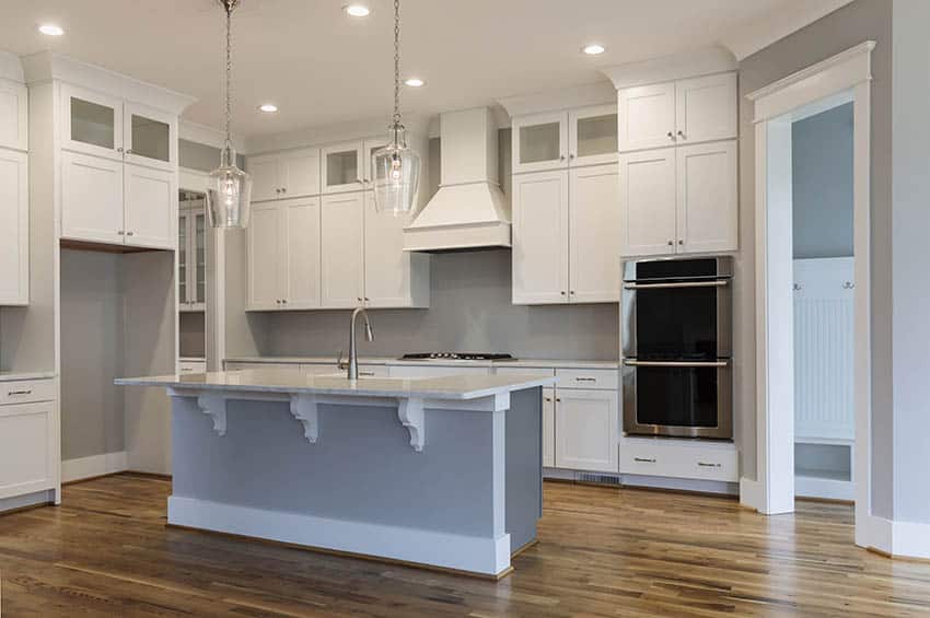 Traditional white cabinet kitchen with gray island and wood floors