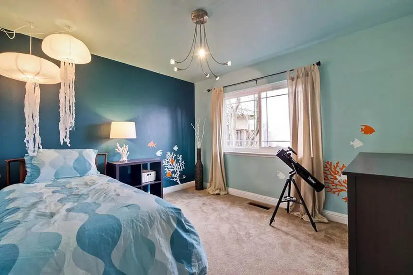 Two tone paint bedroom with soothing blue colors and ocean theme