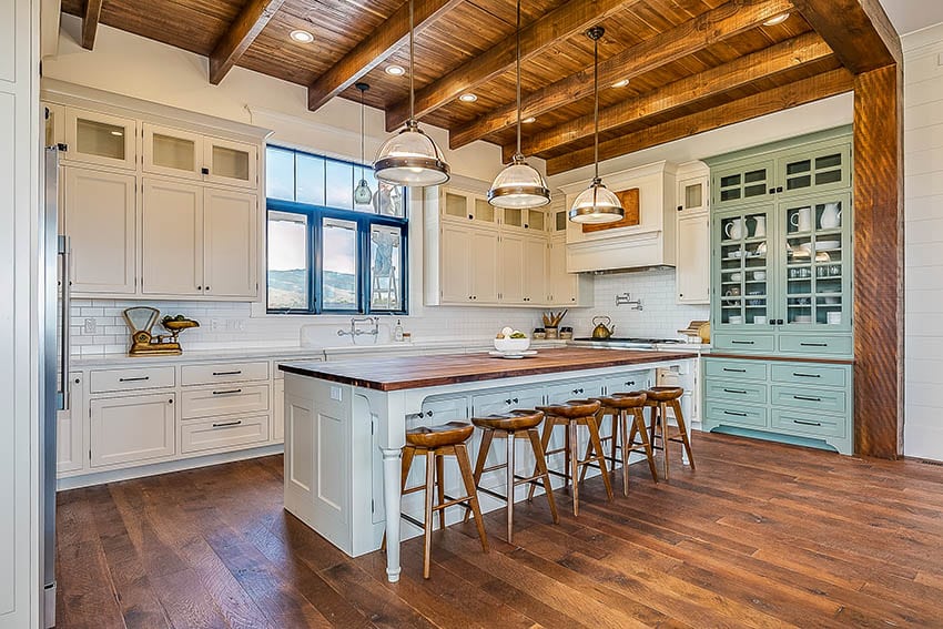 Country kitchen with Bianco Carrara marble counters and exposed beam ceiling