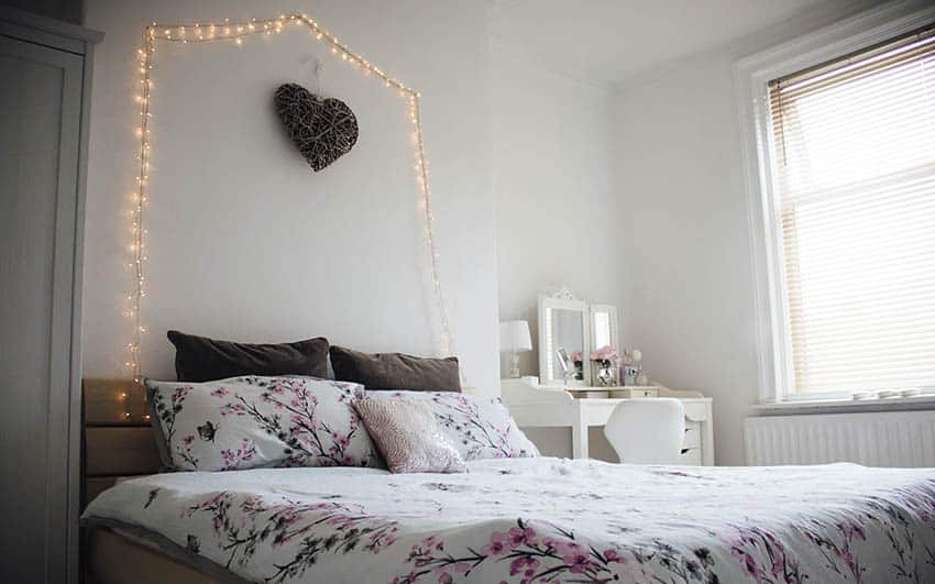 Bedroom with string hanging lights in arch above bed