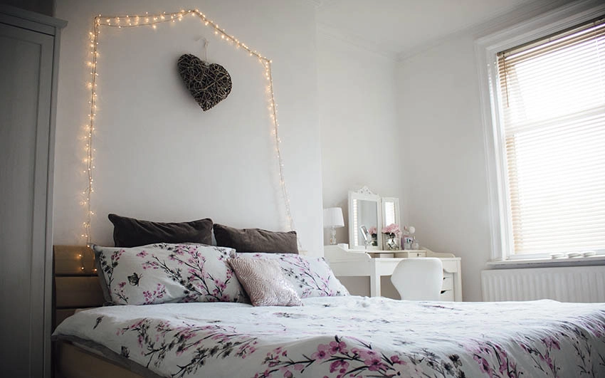 Bedroom with hanging lights in arch above bed