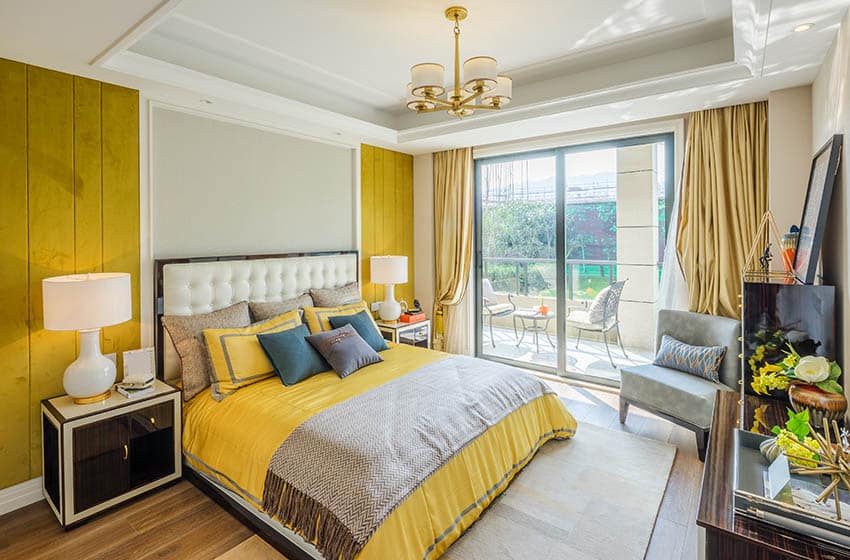 Bedroom with yellow paneling and light-grey panel behind bed