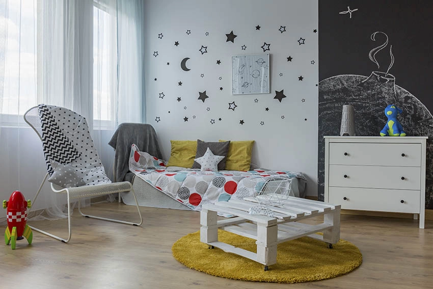 Child's bedroom with hanging stars wall art and chalkboard wall