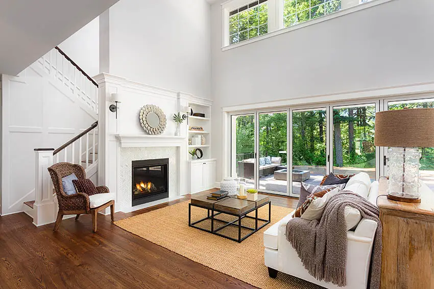 Contemporary living room with large center area rug over wood flooring