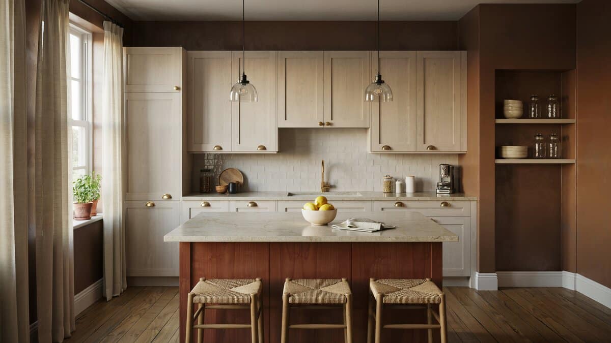 Light ash cabinets and a breakfast bar island with rush seat stools under black pendants