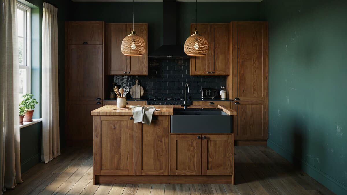 Teal painted walls behind walnut cabinets and an island with a black farmhouse sink