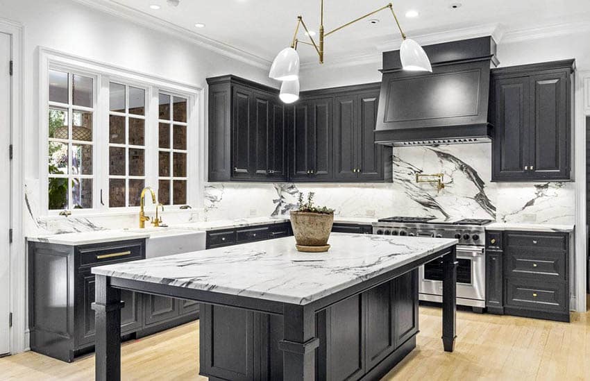 Dark gray and white kitchen with marble countertops backsplash and french windows