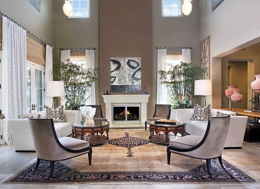 Earth-colored living space with high ceilings fireplace and concrete floors