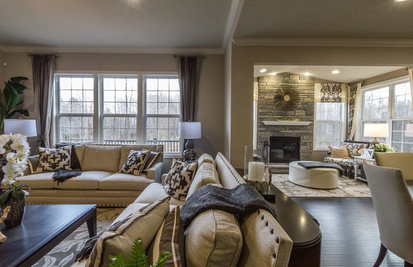 Earth tone living room with stone fireplace and wood floors