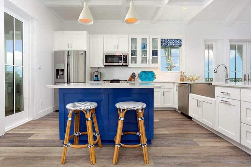 Eclectic beach kitchen with cabinets and bright blue tone island