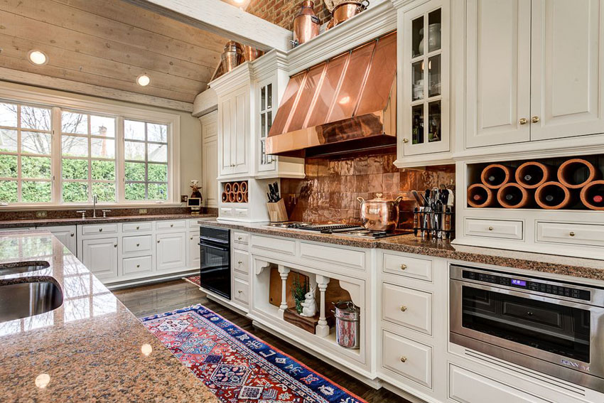 Kitchen with copper accessories above cabinets