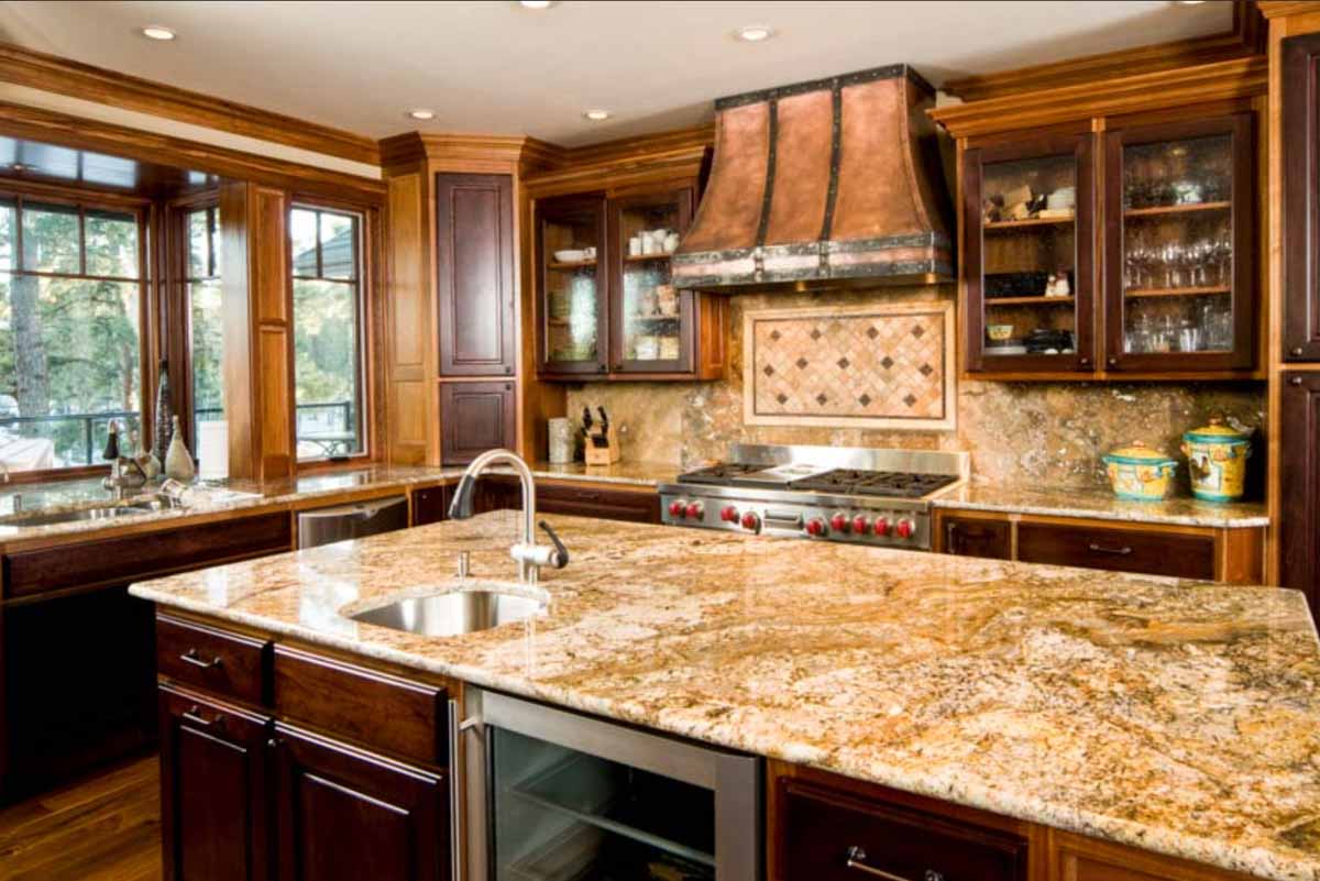 kitchen with gold granite countertop cabinets and windows