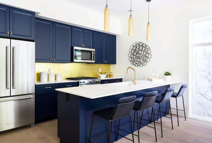 Kitchen with navy cabinets, plank flooring and yellow pendants