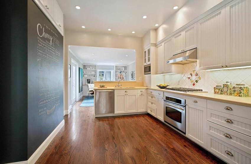 L shaped kitchen with white beadboard cabinets