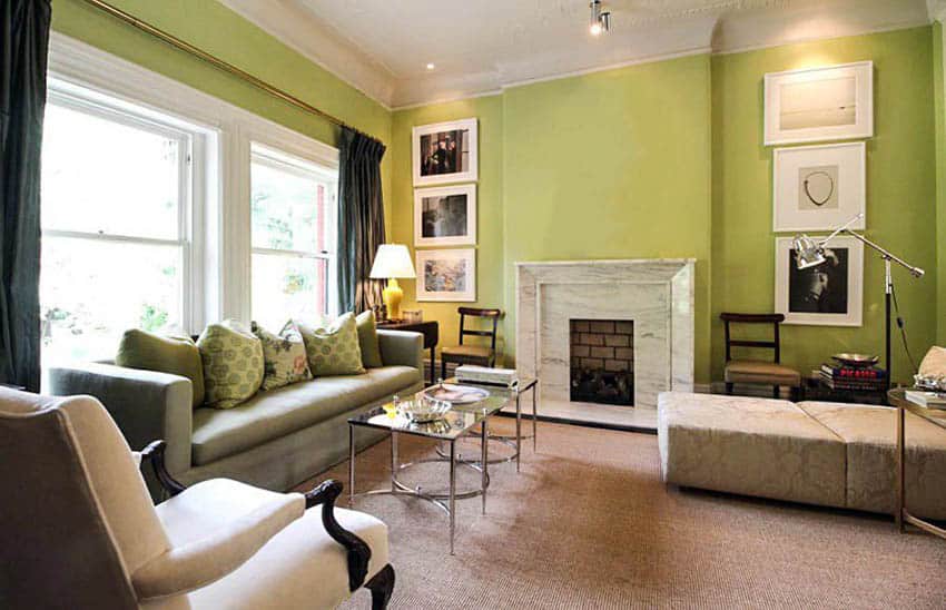 Living room with bright verdant green paint color and white marble fireplace