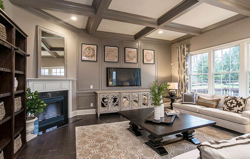 Living room with earth tone paint colors wood floors and box ceiling